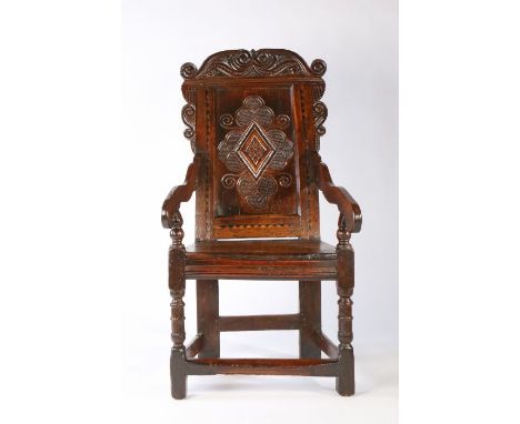 A striking Charles II joined oak and inlaid panel-back open armchair, Leeds, Yorkshire, circa 1670The raked back with a well-