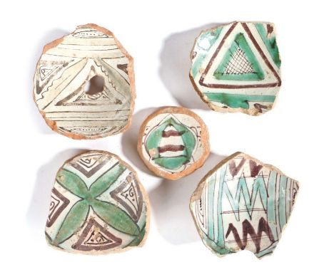 Four 14th century pottery bowl fragments, Paterna or Manises, Spanish, together with a small tile fragment, Toledo, Spain, ci