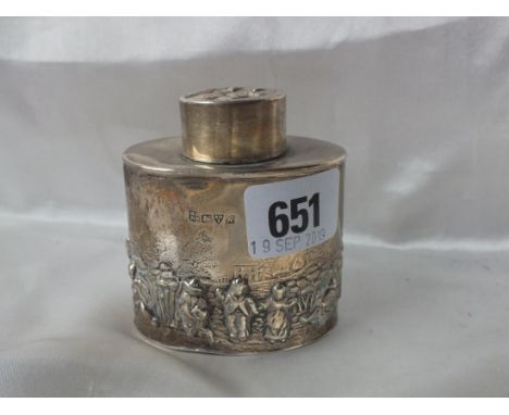 An oval tea caddy, embossed with village figures, Chester 1910 by GH &amp; RH 77g.       