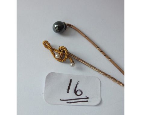 Two pearl mounted stick pins set in gold