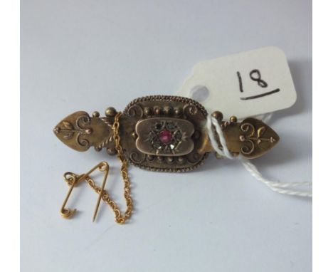 A Victorian 9ct brooch with ruby to centre 4g   