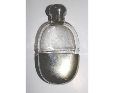 A small glass and silver plated spirit flask