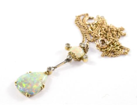 An opal and diamond pendant on gold neckchain