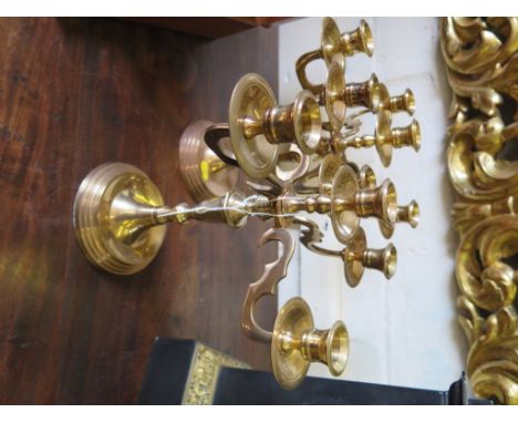 A pair of five light brass candlesticks with scroll arms and circular foot, 29cm high