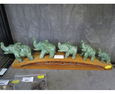 A jade figure group of a five elephant family on a bridge