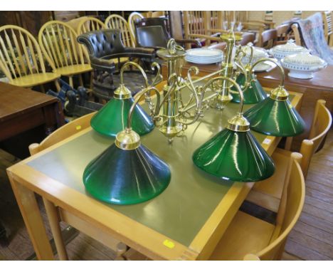 A six light brass snooker table ceiling light, with green glass shades, 110cm long
