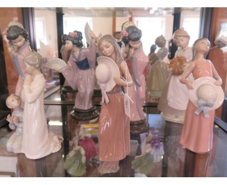 Three Lladro figures of Japanese girls holding fans, two figures of girls holding hats, another of a girl praying and a Nao f