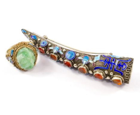 A silver gilt and enamel ring set with a jade plaque togehter with a silver and enamel nail guard