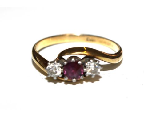 A three stone ruby and diamond ring set in 19 carat gold