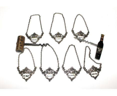 Seven metal and enamel decanter labels and two cork screws