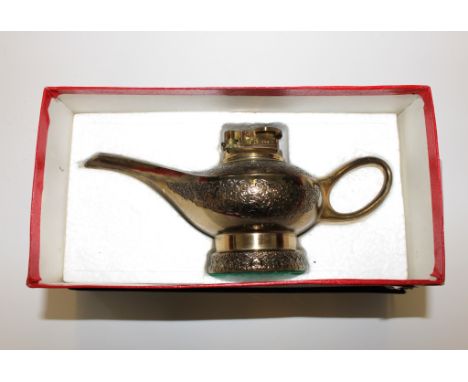 A table lighter in the form of a genie's lamp, boxed, 20cm long