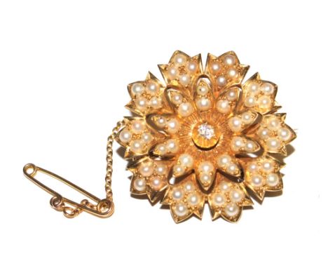 An Edwardian pearl and diamond set flower head brooch