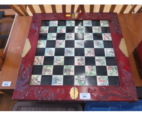 A carved and stained wood Chinese chess set, the resin jade like pieces depicting Chinese figures - pieces still sealed 46cm 