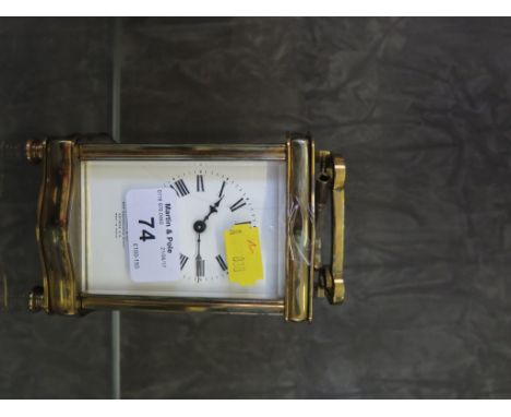 An Edwardian brass carriage clock, with shaped case, the enamel dial inscribed Stewart & Co, 15cm high and another similar (m