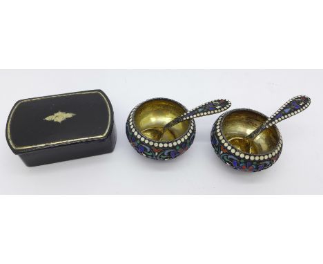 A pair of Russian silver and enamel salts with spoons and a snuff box