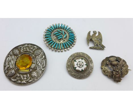 A Scottish hallmarked silver brooch, a silver and enamel brooch, a silver bird brooch and two other brooches, (5)