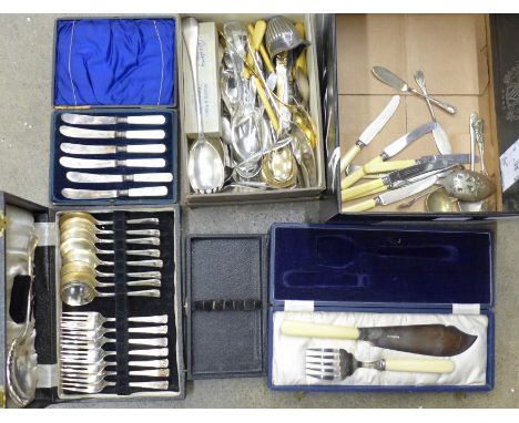 A cased silver spoon and fork and a collection of other plated flatware