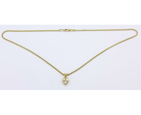 An 18ct gold chain with an 18ct gold and three stone diamond pendant, 5.7g