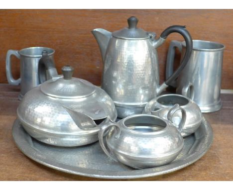 A Hall Brothers hammered pewter four piece tea service and tray and two pewter tankards