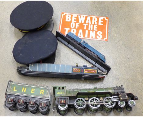 A model of a Flying Scotsman, model barge, one other model train, two railwaymen's hats and a metal sign