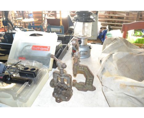 A small bench top cast iron plumbers vice and a bench top punch