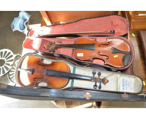 A violin with label, copy of Antonius Stradivarius together with another cased violin and bow