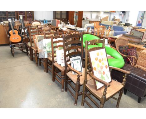A set of six ladder back dining chairs comprising of two carvers, four standards