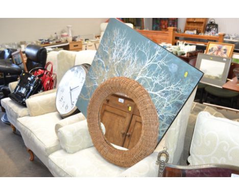 A wicker framed mirror together with a print on board