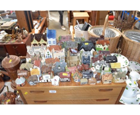 A quantity of various model cottages to include Delft etc.