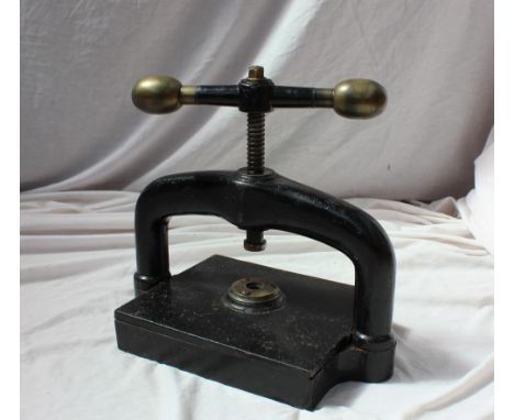 A Victorian cast iron book press with bronze ball handles, 43cm wide x 36cm high 