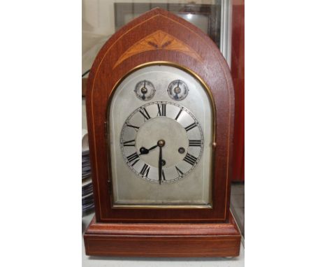 An early 20th century inlaid mahogany bracket clock with a silvered dial and Roman numerals with a three-train movement