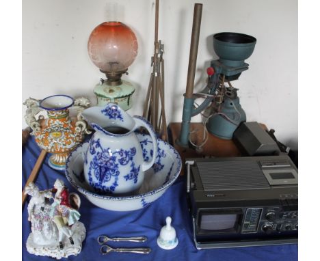 An opaque glass oil lamp together with a blue and white pottery jug and basin set, a continental porcelain figure, a develope