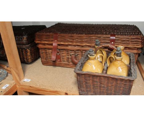 A set of four stoneware decanters for Brandy, Irish Whiskey, Scotch Whiskey and a blank decanter in a wicker carry case toget