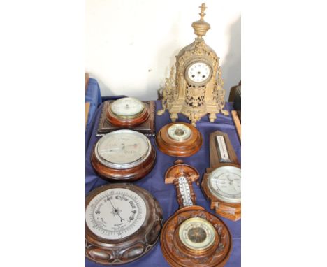 A bronze mantle clock together with aneroid barometers etc