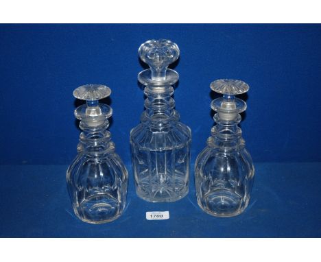 Two dumpy ring necked Decanters, 9" high with stoppers together with a similar ring necked Decanter and stopper, 10 3/4" tall