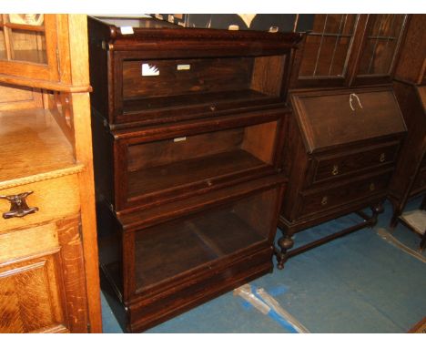 A good Globe Wernicke Oak glazed three tier Bookcase with moulded top over the three stepped and graduated sections, each hav