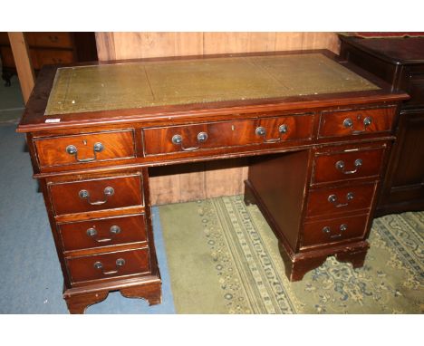 A reproduction Mahogany finished Georgian style Kneehole Desk,  with green leather inset, moulded edge top over long frieze d