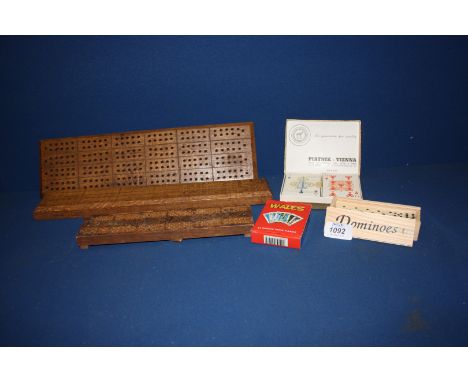 Three wooden cribbage boards, three packs of playing cards, and a box of miniature dominoes