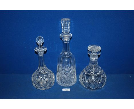 Three cut glass Decanters with stoppers, one being dumpy 9" tall, another dumpy with faceted stopper and a tall decanter with