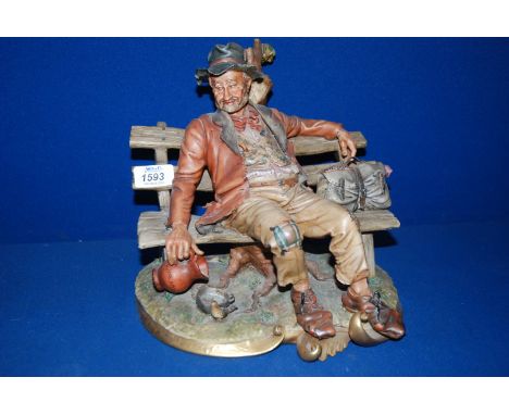 A large Capo di Monte figure of a Tramp on a bench