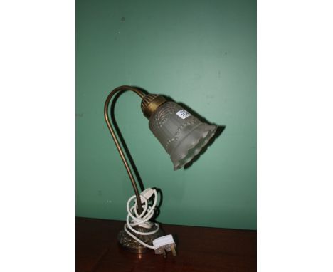 A Brass Desk Lamp with pink glass shade.