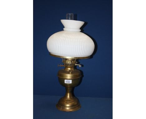 A Brass Oil Lamp with white glass shade.