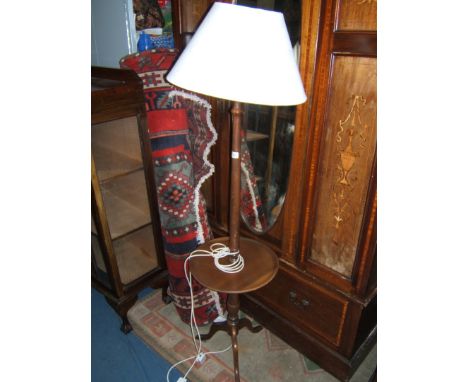 A reproduction Mahogany Standard Lamp, having  turned column on wine table style base with cream shadow patterned shade.