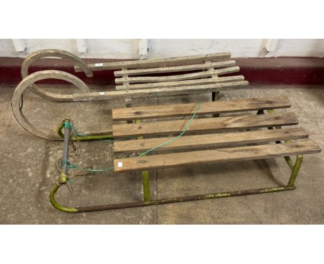 A pine and cast metal sledge and one other 