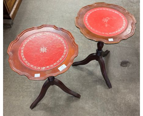 A pair of Regency style mahogany and red leather topped tripod wine tables 