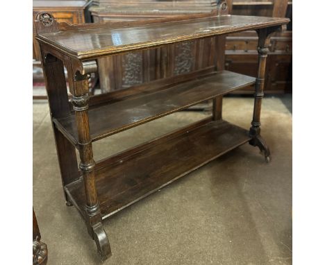 A Victorian Aesthetic Movement oak three tier buffet sideboard 