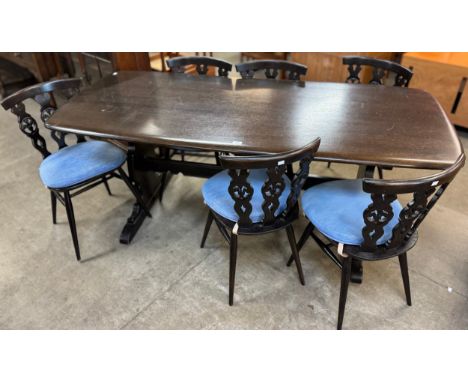 An Ercol Golden Dawn elm dining table and six Ercol Golden Dawn 375 model fleur de lys dining chairs 