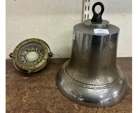 A large cast metal ships bell and a nautical compass 