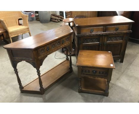An Old Charm carved oak two drawer console table, lamp table and a two door cupboard