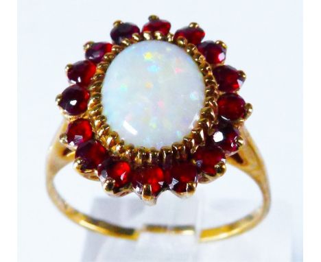 9CT OPAL AND GARNET RING. 9ct yellow gold opal and garnet set ring - 3,3g size O 